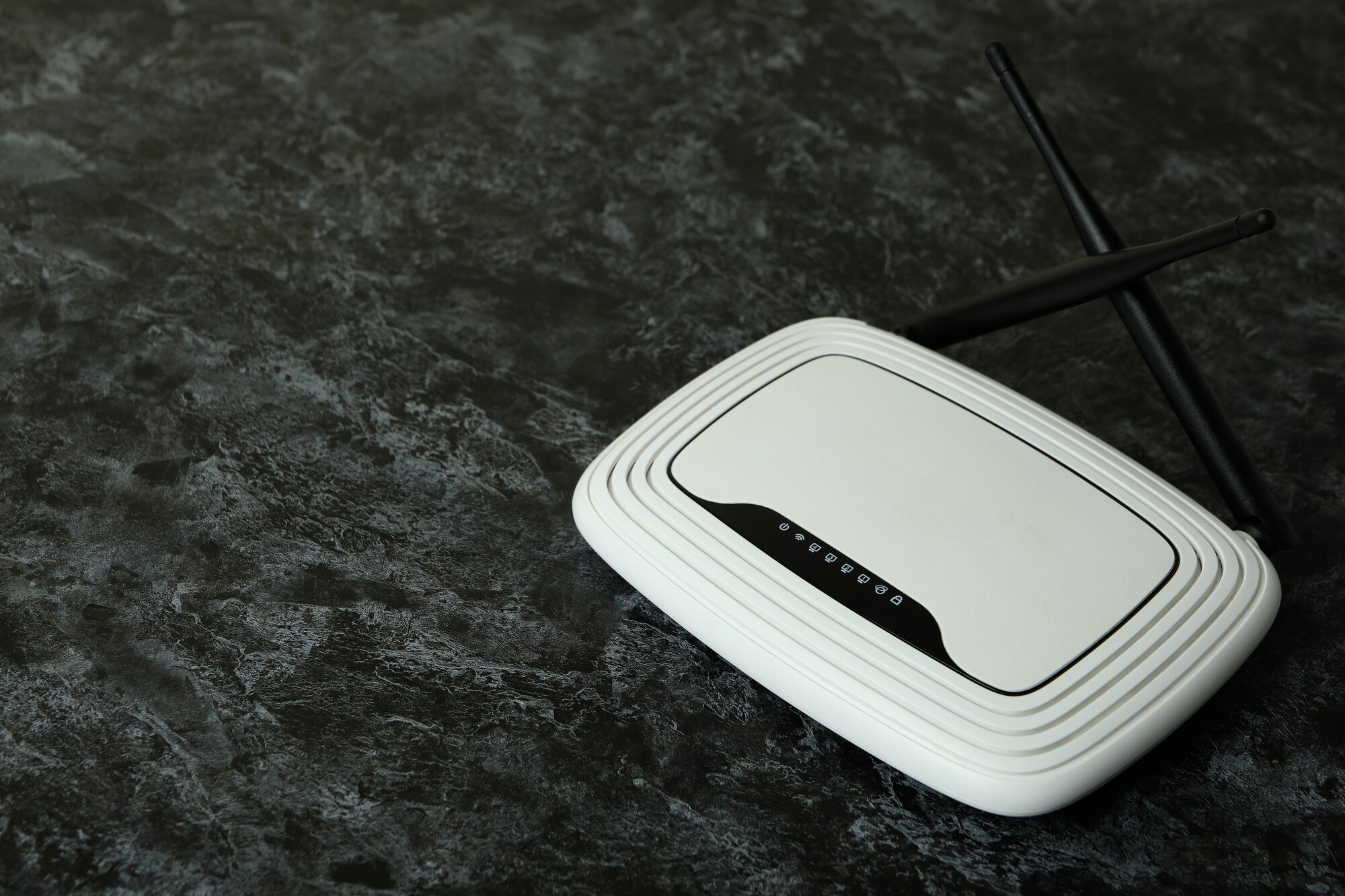 Router Wi-Fi z antenami zewnętrznymi na czarnym przydymionym tle