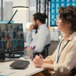Employees sharing ideas on a web video conference call at the workstation discussing about project
