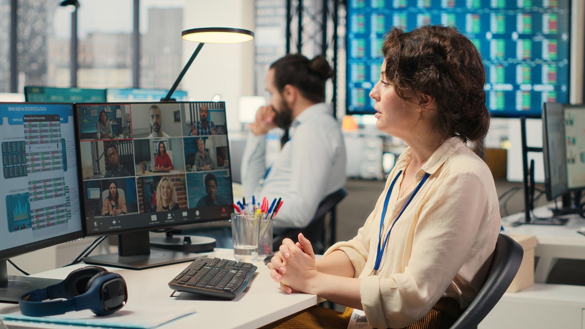 Employees sharing ideas on a web video conference call at the workstation discussing about project
